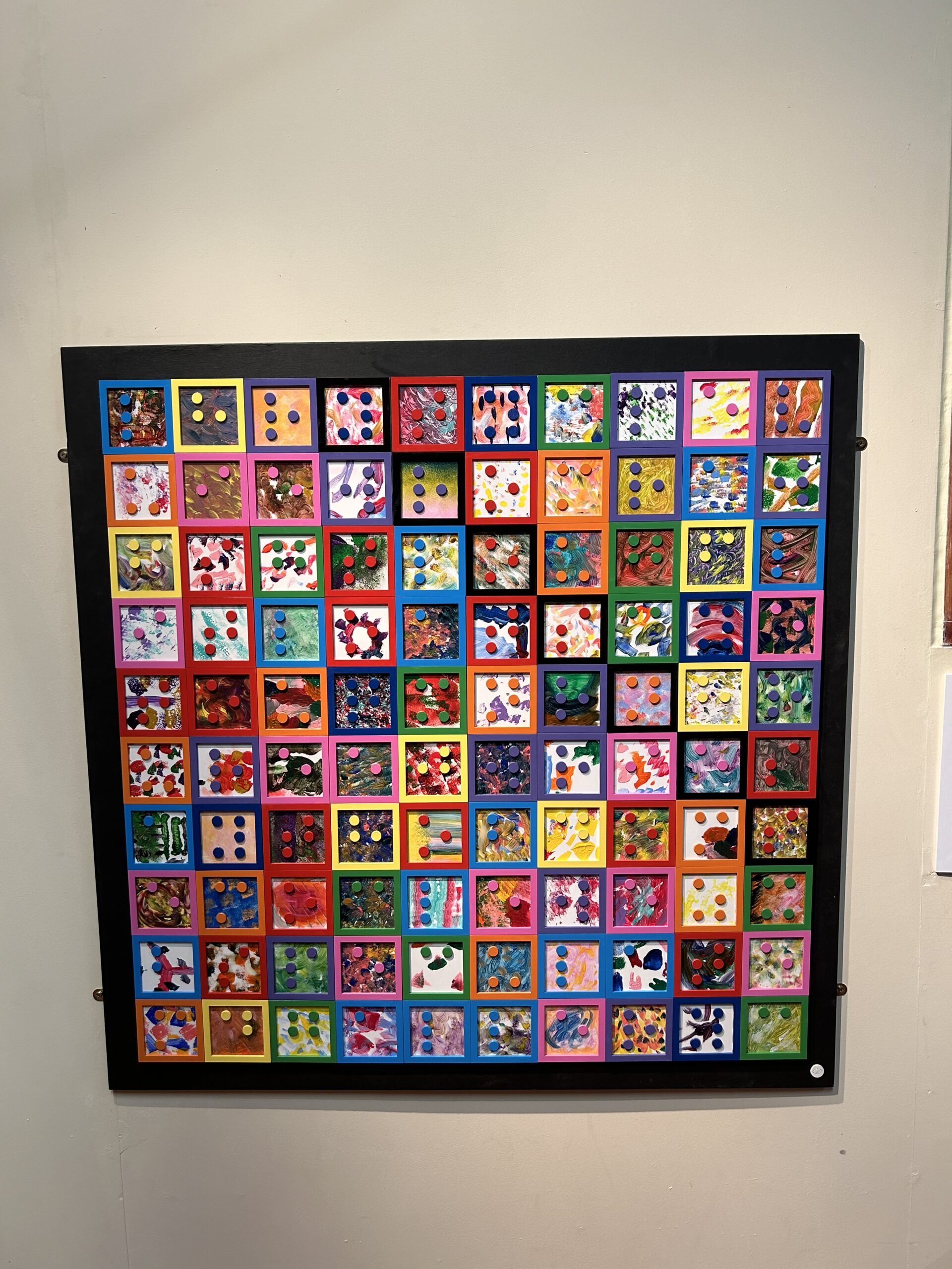 A large braille wordsearch on a board with many different colours and themes in each time